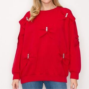 Beautiful red top with bow and rhinestone detail on front and one on each sleeve